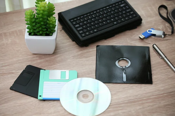 desk with note ,floppy disk A, floppy disk B and memory drive in home office, private office and modern desk in modern life, online market and planning for work, document and paper on desk.