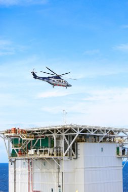 helicopter parking landing on offshore platform, Helicopter transfer crews or passenger to work in offshore oil and gas industry, air transportation for support passenger, ground service in airport. clipart