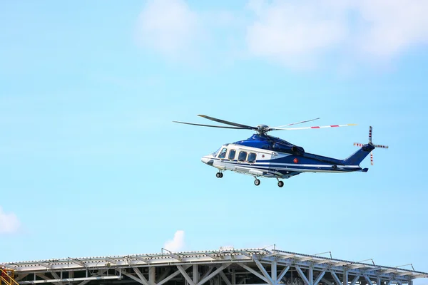 Helicopter parking landing on offshore platform, Helicopter transfer crews or passenger to work in offshore oil and gas industry, air transportation for support passenger, ground service in airport. — Stock Photo, Image