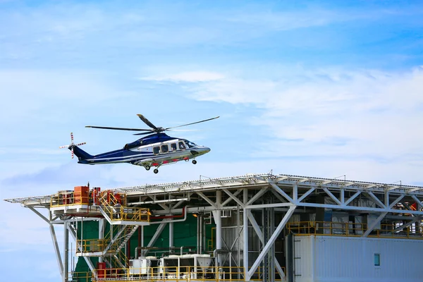 helicopter parking landing on offshore platform, Helicopter transfer crews or passenger to work in offshore oil and gas industry, air transportation for support passenger, ground service in airport.