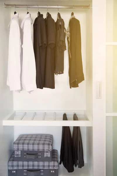 La ropa cuelga en un estante en una tienda de ropa de diseño, armario moderno con fila de ropa colgando en el armario, habitaciones vintage y pertenencias personales guardadas en la habitación que se sienten de lujo y relajarse . — Foto de Stock