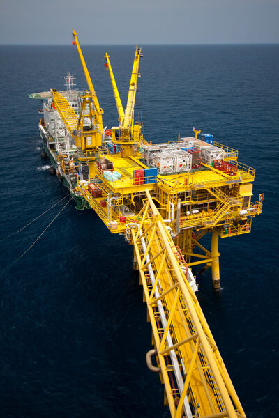 Crane barge doing marine heavy lift installation works in the gulf or the sea