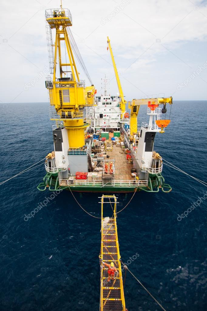 Crane barge doing marine heavy lift installation works in the gulf or the sea