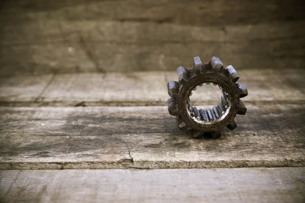 Old machine parts in machinery shop on wooden background.old machine with vintage picture style. — Stock Photo, Image