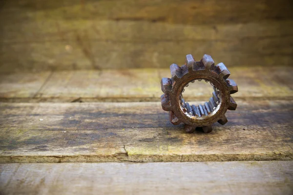 Old machine parts in machinery shop on wooden background.old machine with vintage picture style. — Stock Photo, Image