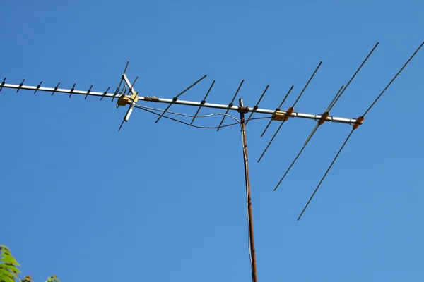 Oude Tv-antenne op huis dak met bule sky — Stockfoto