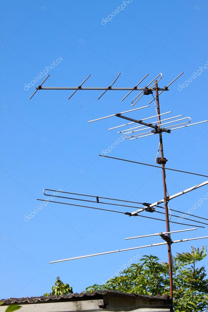 Old Tv Antenna On House Roof With Bule Sky Stock Photo C Curraheeshutter