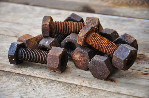 Old bolts or dirty bolts on wooden background, Machine equipment in industry work. — Stock Photo, Image