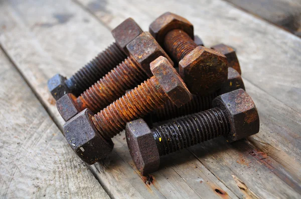 Old bolts or dirty bolts on wooden background, Machine equipment in industry work. — Stock Photo, Image