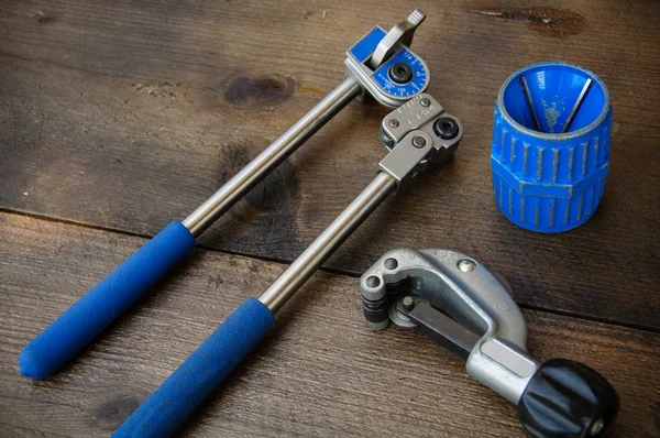 Tube bender or pipe bender tools on wooden background. — Stock Photo, Image