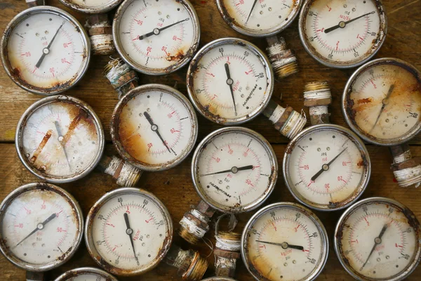 Old pressure gauge or damage pressure gauge of oil and gas industry on wooden background, Equipment of production process. — Stock Photo, Image