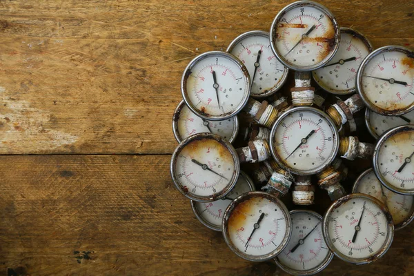 Old pressure gauge or damage pressure gauge of oil and gas industry on wooden background, Equipment of production process. — Stock Photo, Image