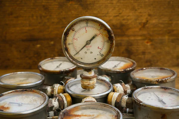 Old pressure gauge or damage pressure gauge of oil and gas industry on wooden background, Equipment of production process. — Stock Photo, Image