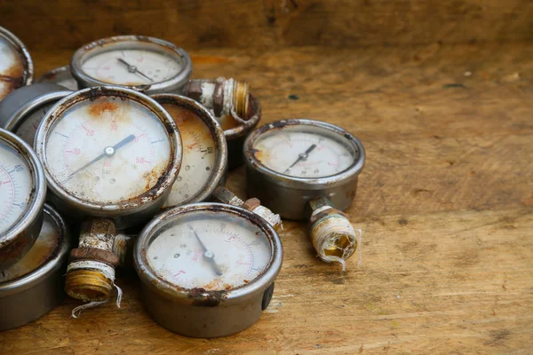 Old pressure gauge or damage pressure gauge of oil and gas industry on wooden background, Equipment of production process. — Stock Photo, Image