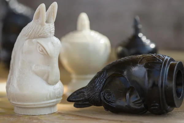 stock image Chess pieces on wooden table, Planing game. chess uniqueness concept on the wooden background.