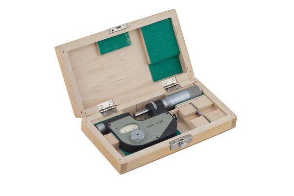 Micrometer in a wooden box on a white background