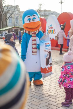 Kiev (Kiev), Ukraine - January 2, 2021: A man in a blue penguin costume advertises Kinder Pingui on a city street. Promotion