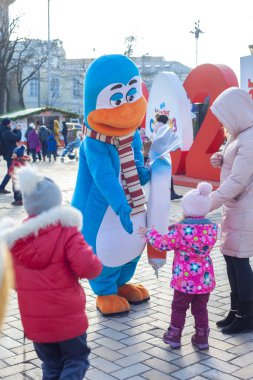 Kiev (Kiev), Ukraine - January 2, 2021: A man in a blue penguin costume advertises Kinder Pingui on a city street. Promotion