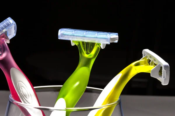 Three Women Colorful Razors Selective Focus Glass Beaker Black Background — Stock Photo, Image