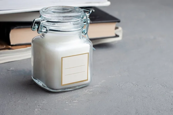 cosmetic or candles, green glass bottles with lids and eucalyptus messages. Close-up, minimalist branded packaging mockup