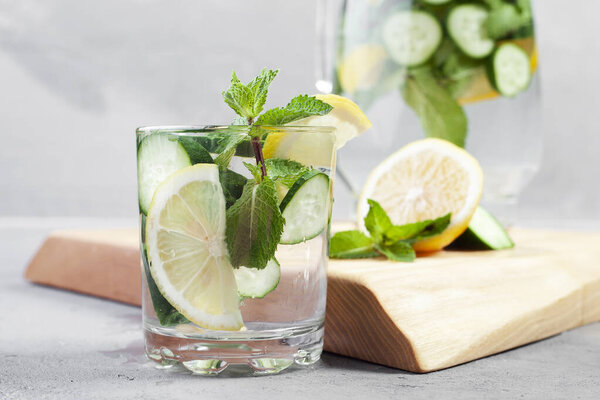 Fresh cool detox water drink with cucumber and lemon. glass of Lemonade with basil and mint leaves. Concept of proper nutrition and healthy eating. Fitness diet. Copy space for tex