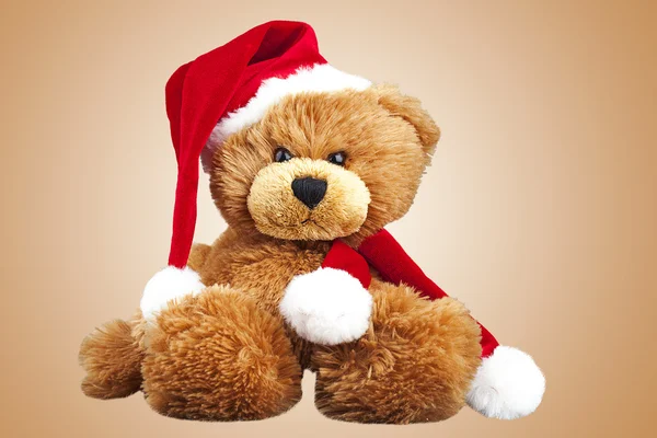 Urso de peluche em um boné de Papai Noel Fotografias De Stock Royalty-Free