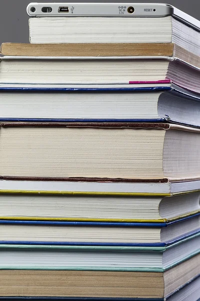 E-book and glasses on a background paper books