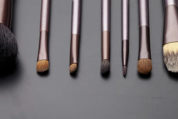 Set of makeup brushes on a black background — Stock Photo, Image