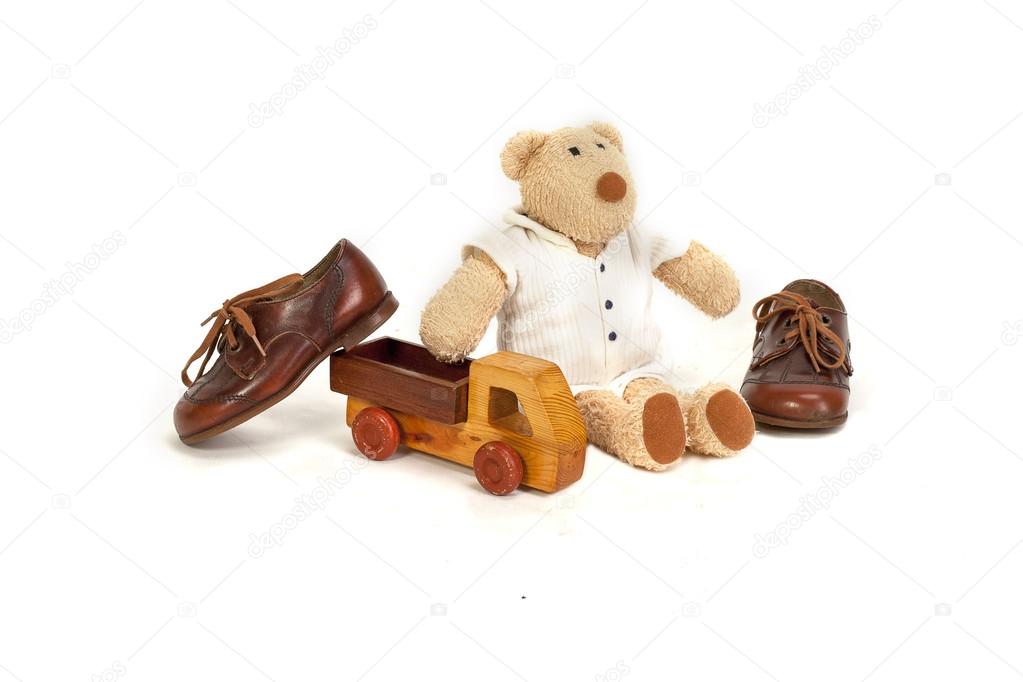 Set for boy, eco toys and expensive shoes on a white background