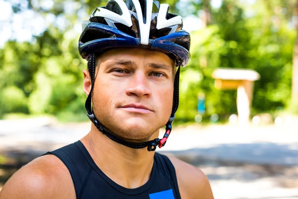 Professional cyclist smiling with helmet on the head for safety — Stock Fotó