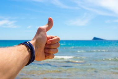 Closeup picture of mans hand on sea background