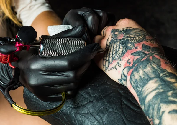 Tattooist makes a tattoo on clients arm — Stock Photo, Image