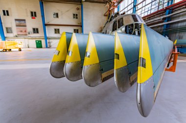 Helicopter rotor blades in hangar clipart