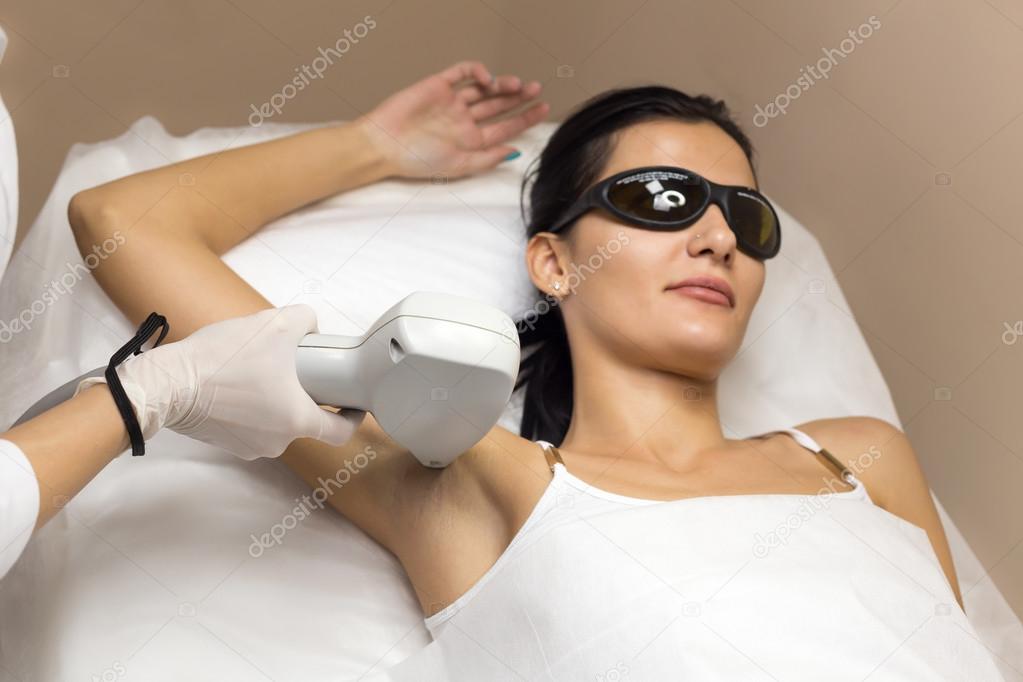Woman having underarm Laser hair removal epilation