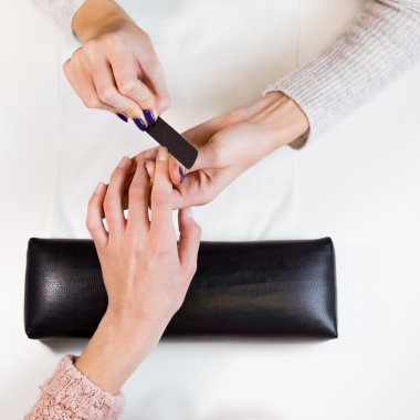 Image of hands polishing index finger