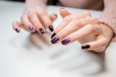 Finished shellac manicure girl in beauty salon