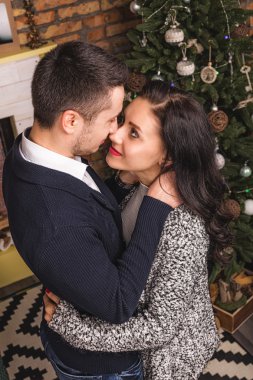 Top view love couple hugging Christmas fireplace