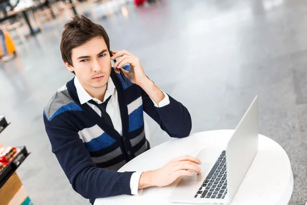 Freelancer trabaja en la computadora y habla por teléfono — Foto de Stock