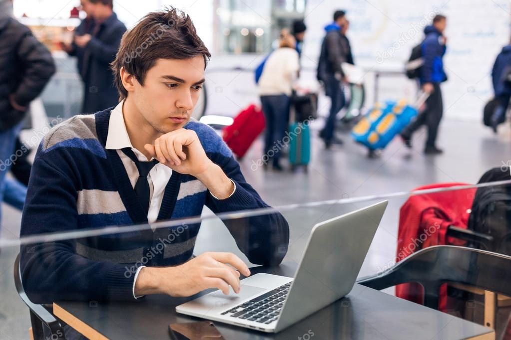 Freelancer working with a laptop in train station