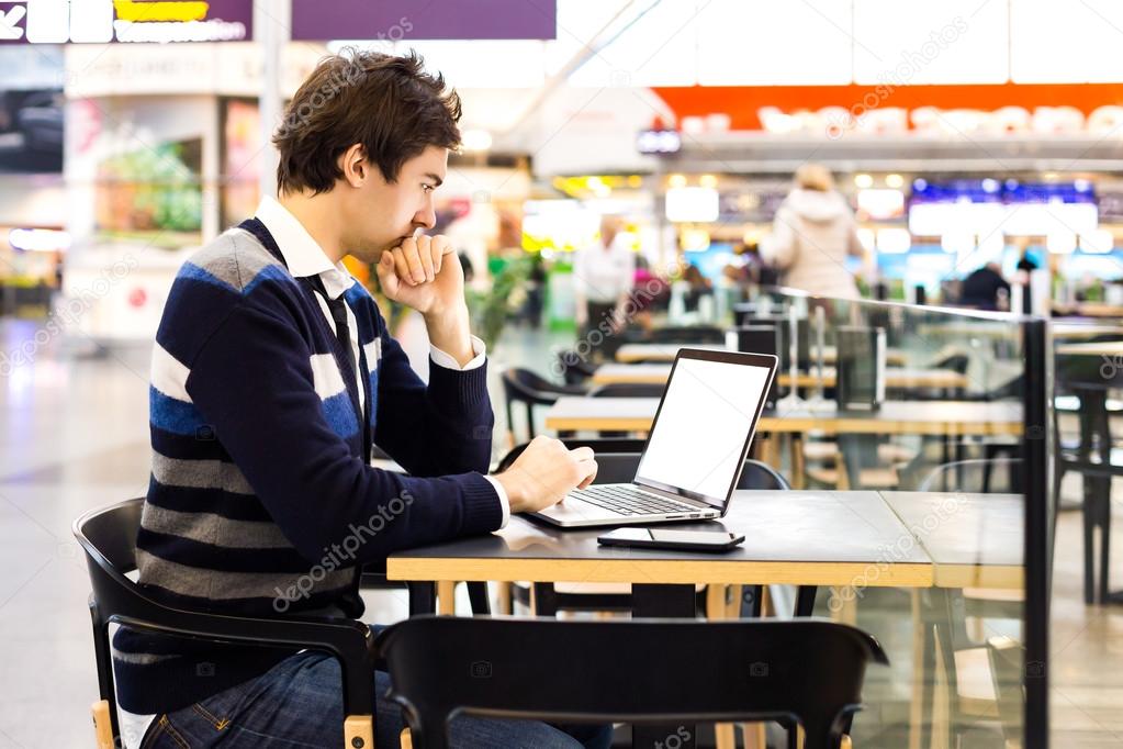 Business man connecting to wireless on his laptop