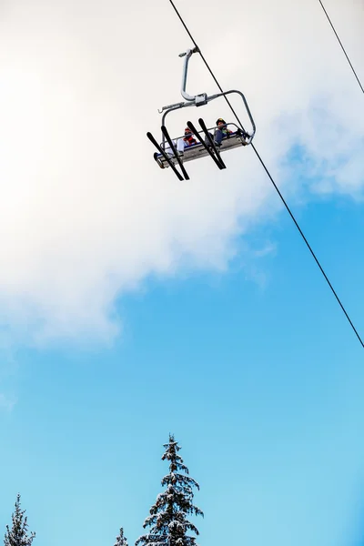 Bottom view ski family on chair lift — Stock Photo, Image