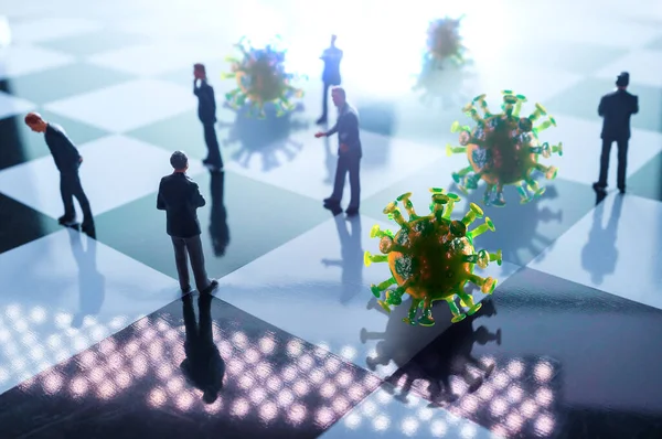 Miniature businessmen practicing social distancing to slow the spread of the deadly coronavirus