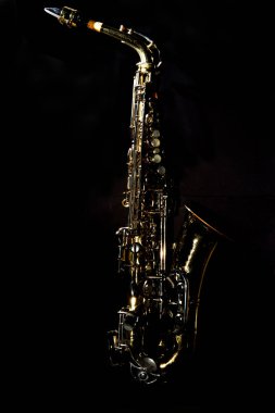Old dented worn alto Jazz saxophone on plain background clipart