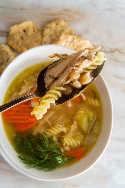 Winter cold cure chicken noodle soup with hexagon multigrain crackers — Stock Image Winter Cold Cure Chicken Noodle Soup Hexagon Multigrain Crackers Stock Photo
