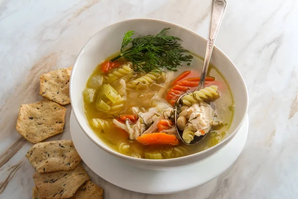 Winter cold cure chicken noodle soup with hexagon multigrain crackers — Stock Image Winter Cold Cure Chicken Noodle Soup Hexagon Multigrain Crackers Stock Picture