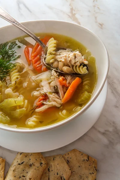 Winter cold cure chicken noodle soup with hexagon multigrain crackers — Stock Image Winter Cold Cure Chicken Noodle Soup Hexagon Multigrain Crackers Stock Image