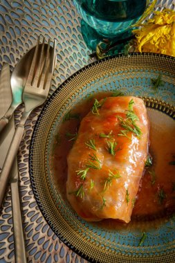 Polish cuisine stuffed cabbage roll garnished with fresh dill clipart