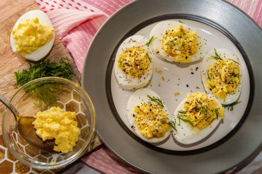Stuffed Russian deviled eggs topped with everything bagel seasoning clipart
