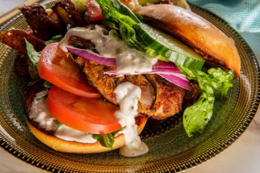 Yunan hindi burgeri, salatalık dilimleri ve tzatziki yoğurt sosuyla kaplı. Akdeniz sokak arabasıyla servis edilen kızarmış patates, peynir, zeytin ve baharat.