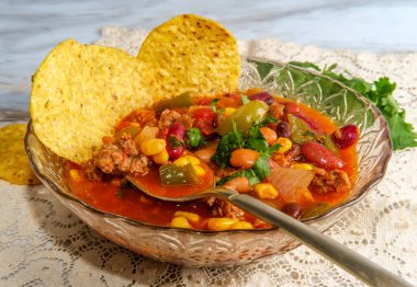 Chorizo sausage chili con carne dinner with corn tortilla chips 